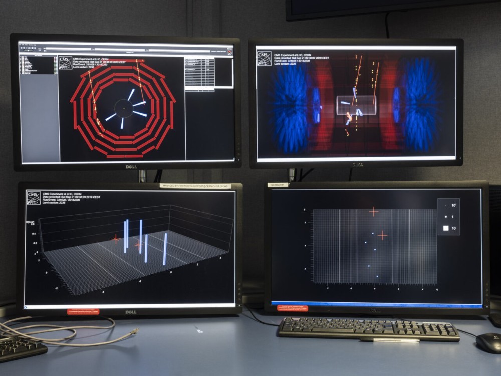Four screens show some particle event displays recorded by the Large Hadron Collider. The four screens are at CERN's Control Room. Photo by Armin Linke