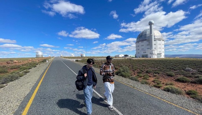 Kamil Hassim and Ian Purnell walking by the SALT Telescope